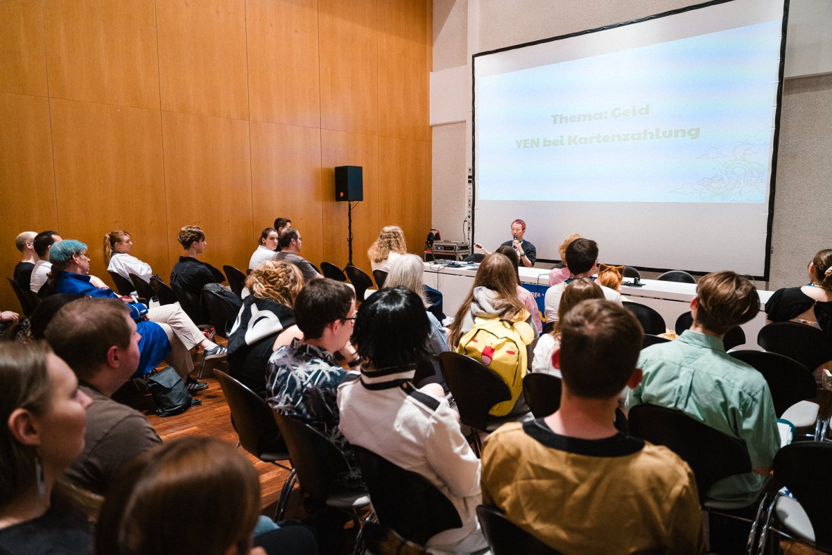 Audience at a programme item with a guest of honour in the lecture hall
